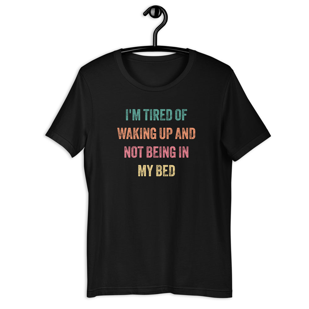 The "I'm Tired of Waking Up and Not Being In My Bed" T-shirt is a humorous and relatable way to express the desire for the comfort and familiarity of your own bed. The shirt features bold, attention-grabbing text in a playful font that reads "I'm Tired of Waking Up and Not Being In My Bed."