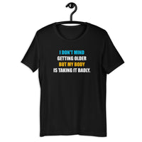 Load image into Gallery viewer, I Don't Mind Getting Older But My Body Is Taking It Badly t-shirt - SHOPNOO
