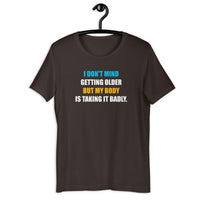 Load image into Gallery viewer, I Don't Mind Getting Older But My Body Is Taking It Badly t-shirt - SHOPNOO
